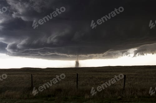 Preview: Tornado touches down under dark storm clouds.