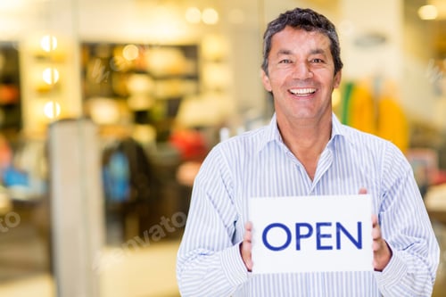 Preview: Male Business Owner Holding An Open Sign And Smiling