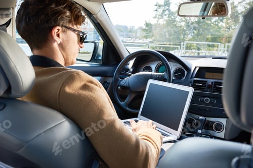 Preview: Successful Business Person Using Laptop in Car