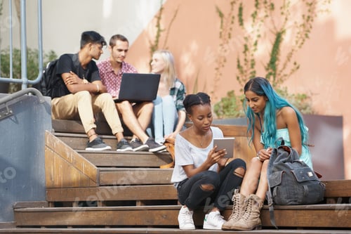 Preview: The students stairs. Shot of a group of young students enjoying a break outdoors on campus.
