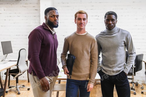 Preview: Confident businessmen posing in coworking space