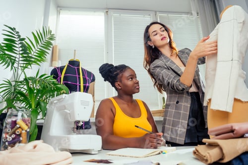 Preview: beautiful woman seamstress with long hair and afro customer.