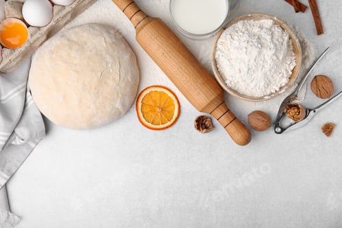 Preview: Flat lay composition with dough and flour on white table. Space for text