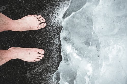 Preview: Bare feet on the Black sands with an Iceberg