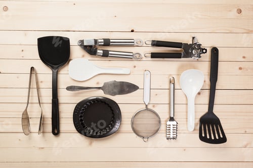 Preview: cookware and accessories on a wooden table.