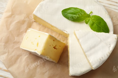 Preview: Baking paper with camembert cheese and basil, close up