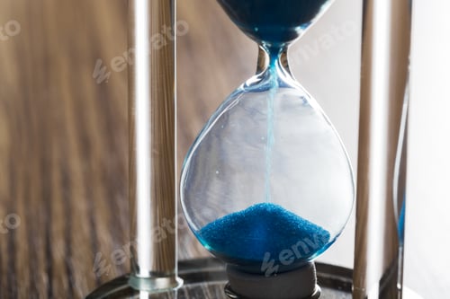 Preview: Time is passing. Blue hourglass close up