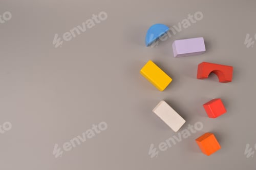 Preview: Colorful toy building blocks with copy space on grey background