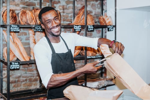 Preview: Smiling man working in a bakery