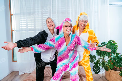Preview: Beautiful senior women having funny pajama party at home