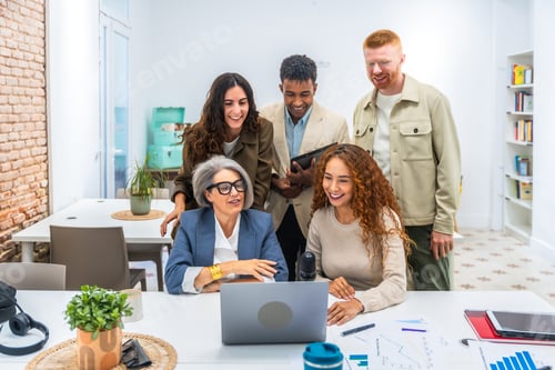 Preview: Diverse team collaborating on business project in modern office