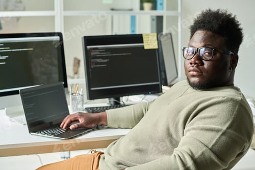 Preview: IT programmer working on laptop at office