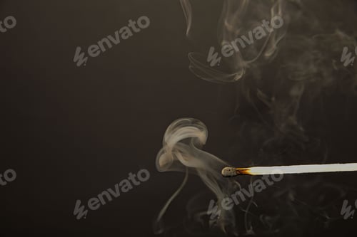 Preview: a burnt out match with smoke