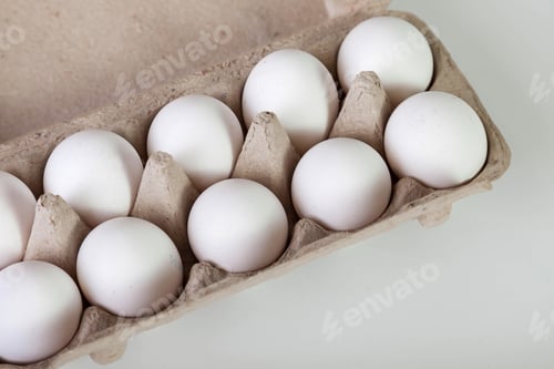 Preview: Fresh White Eggs Filling a Brown Recycled Pulp Carton on White Background