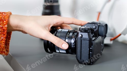Preview: Female hand taking a camera