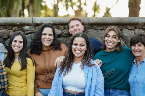 Preview: Group of multi generational people having fun together outdoor while smiling on camera