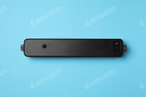 Preview: Sealer for vacuum packing on turquoise background, top view