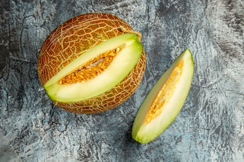 Preview: top view sliced fresh melon on dark-light background sweet fruit summer mellow