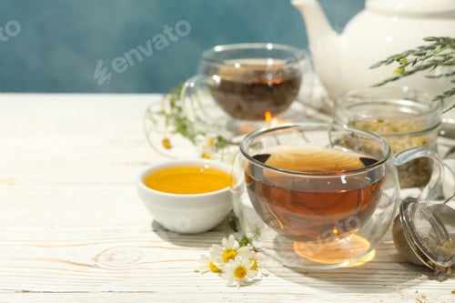 Preview: Composition with chamomile tea on white wooden table