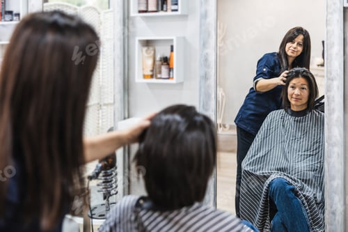 Preview: Woman Receiving Haircut at Salon with Mirror Reflection