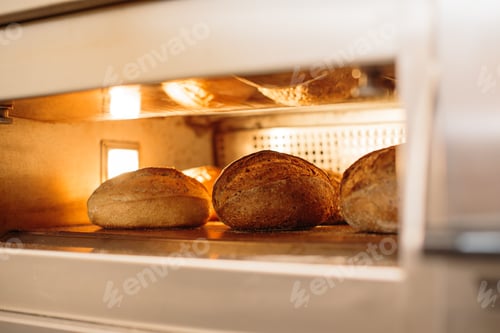 Preview: Bread is baked in the oven. Bakery concept.