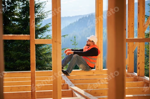 Preview: Carpenter constructing wooden frame house.
