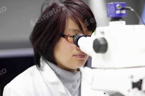 Preview: Scientist using microscope in lab