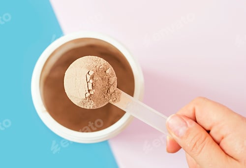 Preview: Chocolate protein powder in scoop and plastic jar on blue and pink background.