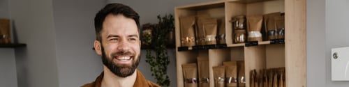 Preview: Happy mid aged farmer selling onions at the market