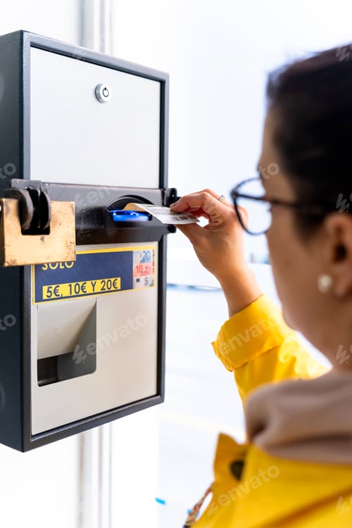 Preview: Woman changing money from bills to coins in an automatic machine