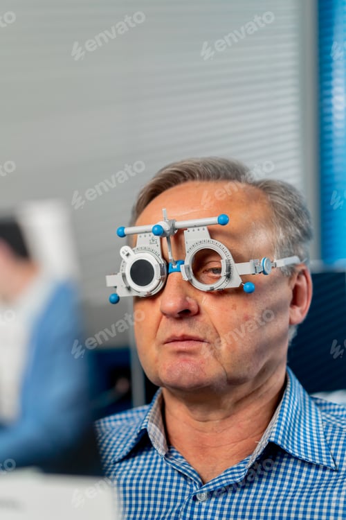 Preview: close up in an ophthalmology clinic elderly patient selects a lens checks vision by reading
