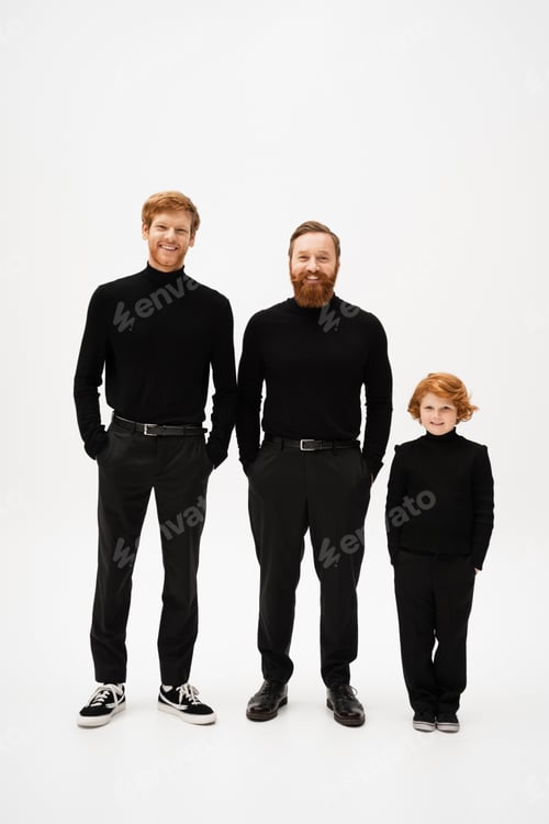 Preview: full length of cheerful bearded men with red haired kid in black clothes standing with hands in