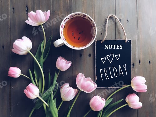 Preview: Overhead shot of pink tulips with a cup of tea and a blackboard saying FRIDAY