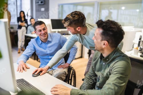 Preview: Young professionals collaborating on computer project in coworking space