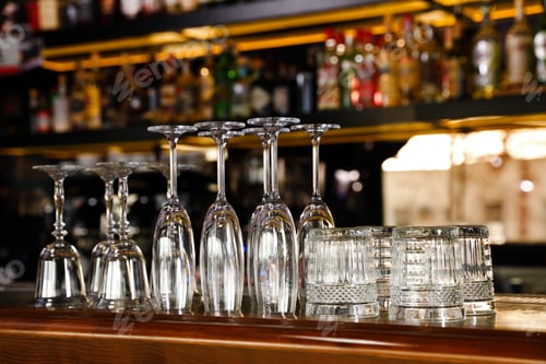 Preview: Different empty clean glasses on counter in bar