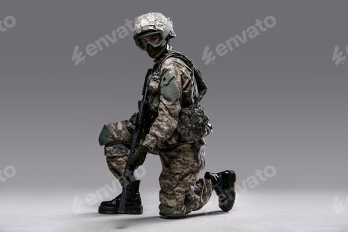 Preview: Modern servicewoman with rifle sitting against grey background
