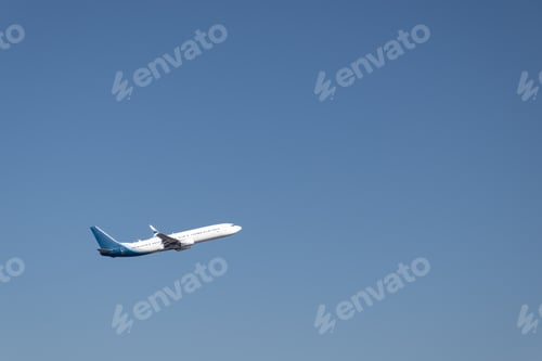Preview: Airplane flying in the sky with blue background and space for text