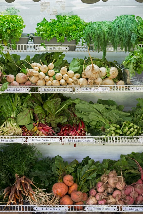 Preview: A farm stand with rows of freshly picked vegetables for sale.