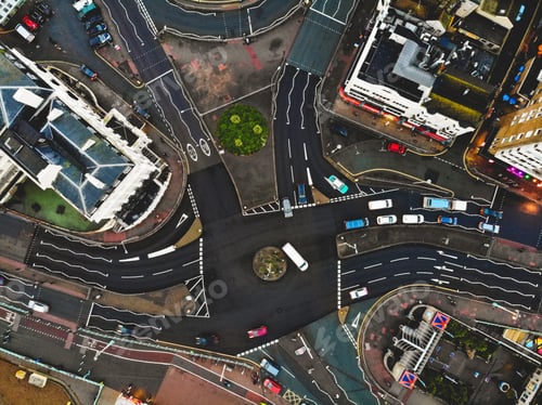 Preview: Drone shot looking down on busy street roundabout and cars passing in city of Brighton, England