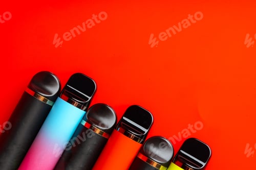 Preview: Colorful disposable electronic cigarettes on red background