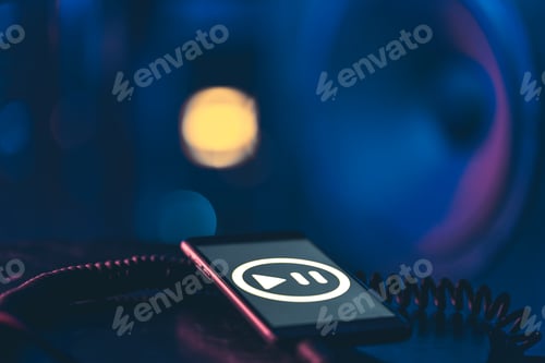 Preview: Phone with music listening icon on screen on dark background, copy space.