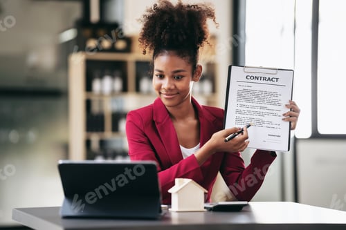 Preview: African american businesswoman in suit using tablet to video con