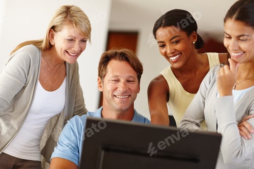 Preview: Taking pride in their work together. Shot of a work team gathered around a computer.