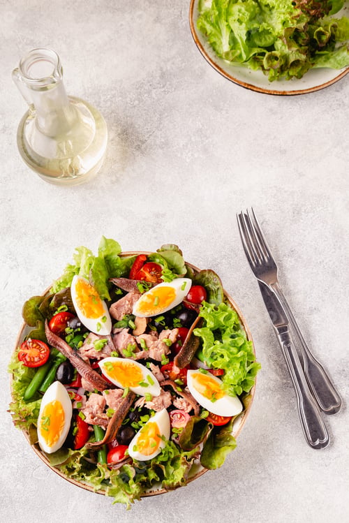 Preview: salad Nicoise with tuna, eggs, green beans, tomatoes, olives, lettuce and anchovies