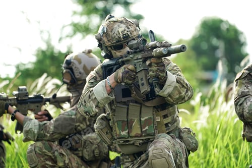 Preview: Soldier in full US MARSOC armed with assault rifle run through the abandoned building. Military