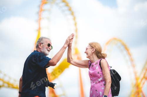 Preview: happy senior friend couples enjoy in amusement water park with icecream and photography