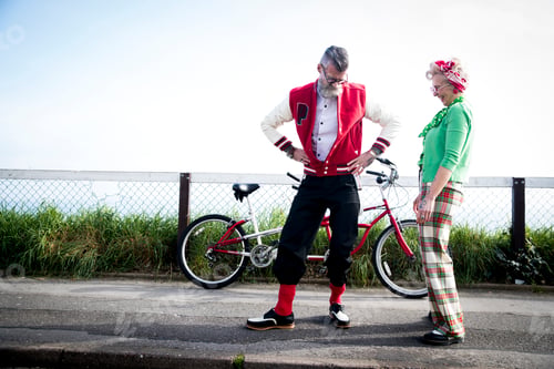 Preview: Quirky couple sightseeing on tandem bicycle, Bournemouth, England