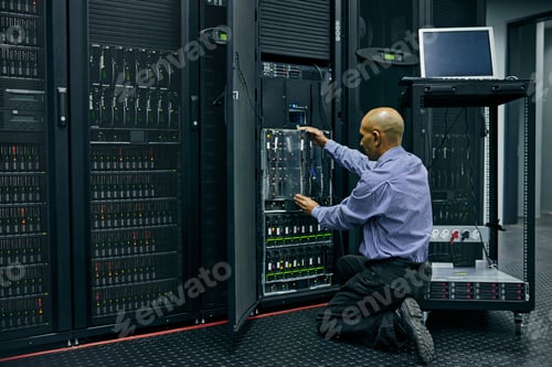 Preview: Shot of an IT technician repairing a computer in a data center
