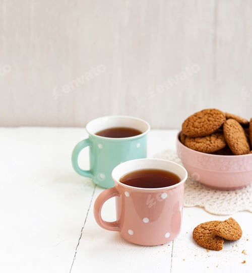 Preview: A tasty snack: two cups of tea and a bowl of cookies.