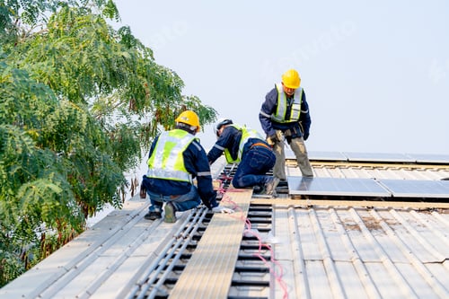 Preview: workers installing solar panels, for efficient energy on rooftop
